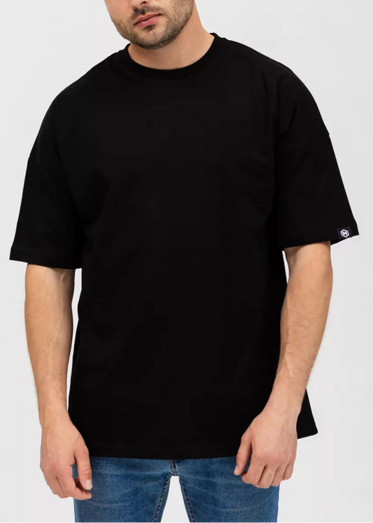 Man wearing a black t-shirt against a plain background